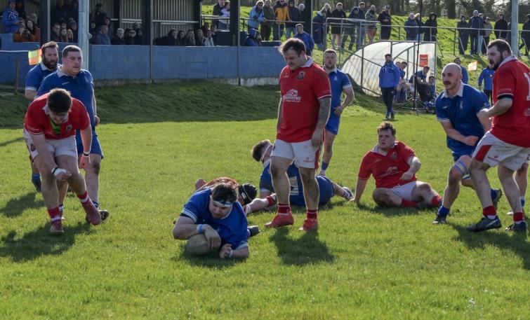 Karl Busch ploughs over for one of his three tries. Picture William John